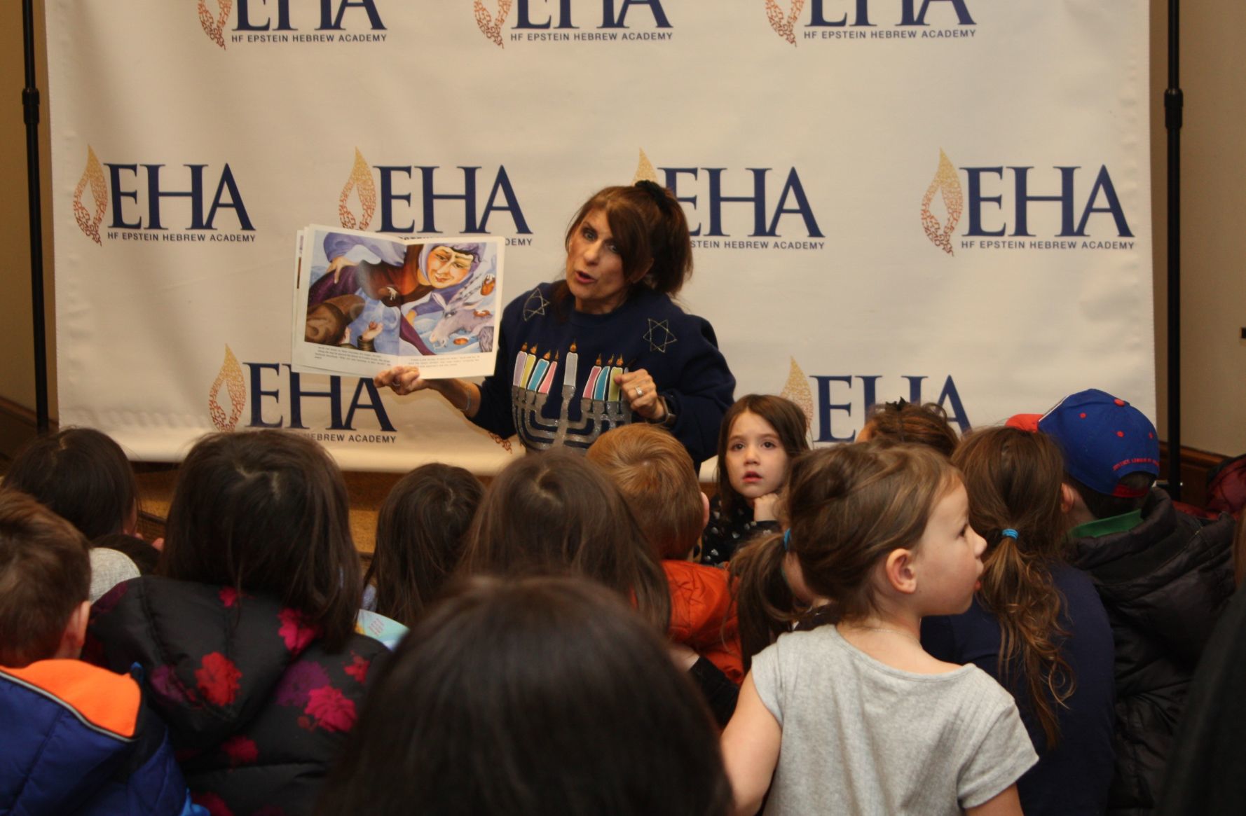 Jackie Oppenheimer reading to Hanukkah Celebration attendees.jpg